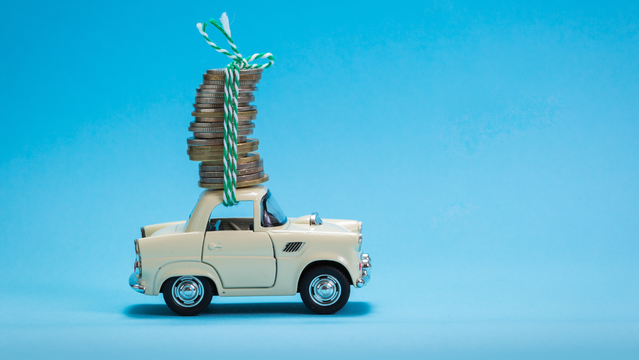 The image displays a car carrying coins. This represents the increase in HMRC Recommended rate to 55ppm